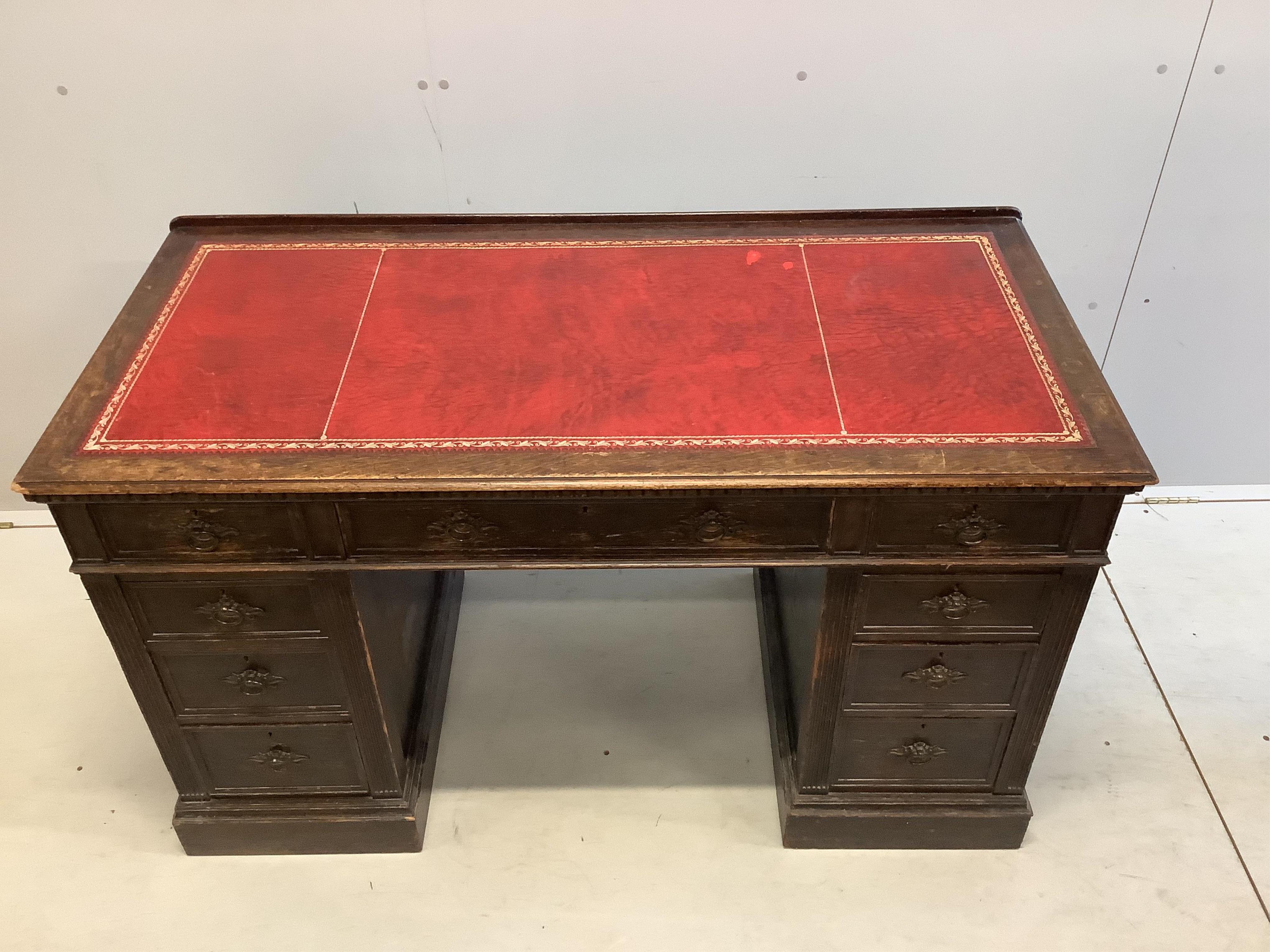 A late Victorian oak pedestal desk, width 128cm, depth 61cm, height 77cm. Condition - fair